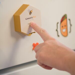 Tapping GroceryBee on the fridge to scan.